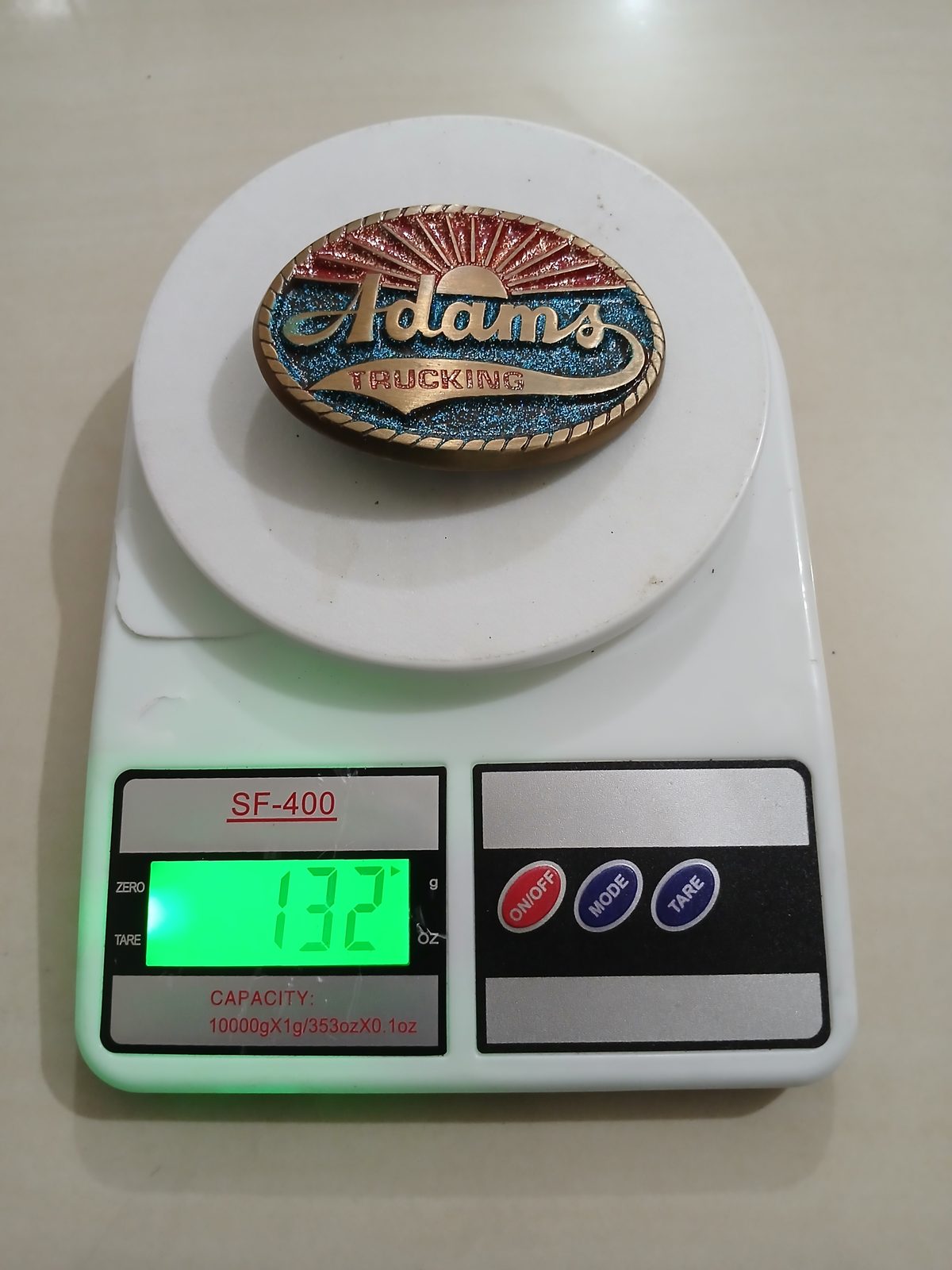 Adams Trucking Vintage Belt Buckle – On scale showing weight Adams Trucking vintage belt buckle – on scale showing weight