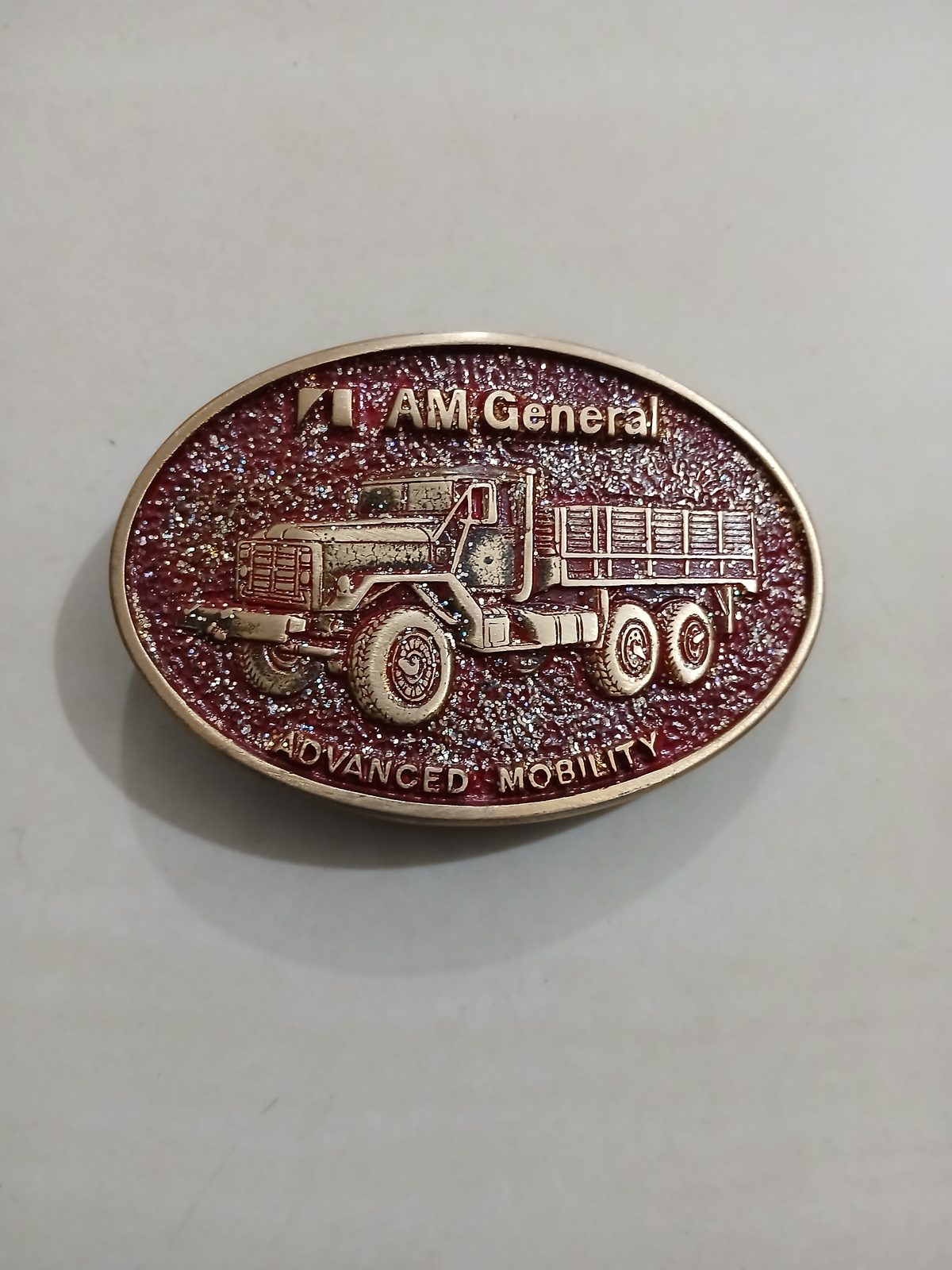 AM General Advanced Mobility Vintage Belt Buckle – Front view AM General Advanced Mobility vintage belt buckle – front view