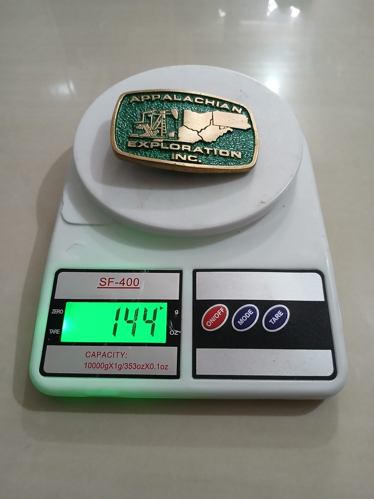 Appalachian Exploration Inc Vintage Belt Buckle – On scale showing weight Appalachian Exploration Inc vintage belt buckle – on scale showing weight
