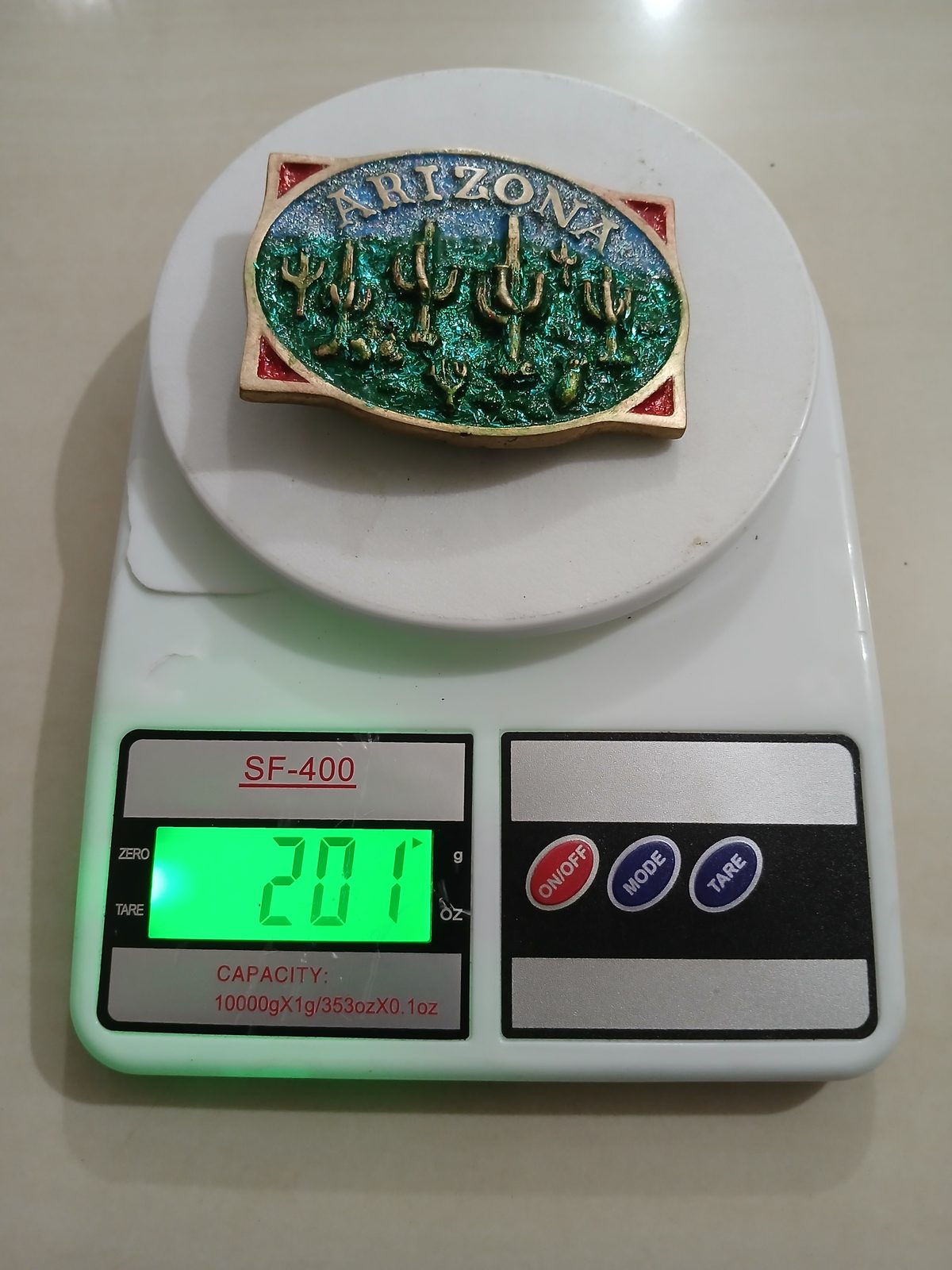 Arizona Saguaro Cactus Vintage Belt Buckle – On scale showing weight Arizona Saguaro Cactus vintage belt buckle – on scale showing weight