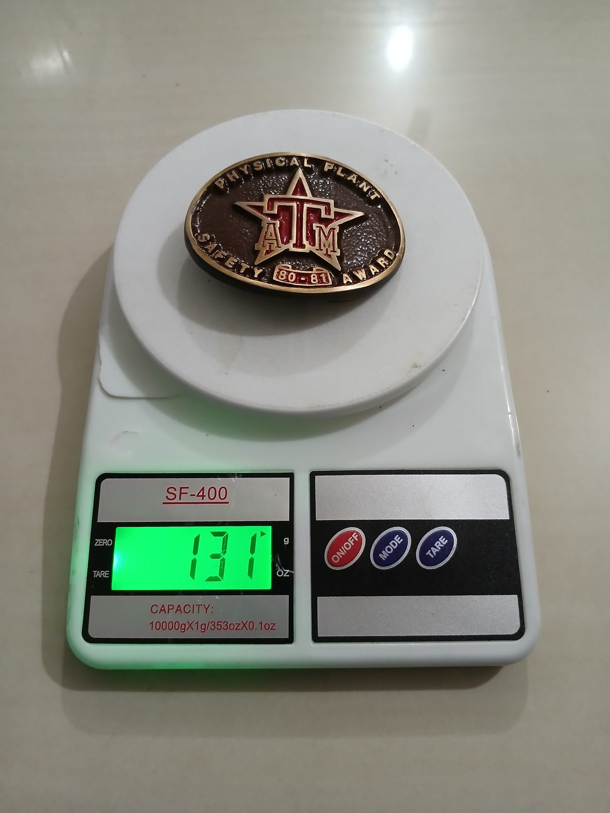 ATM Safety Award 80-81 Vintage Belt Buckle – On scale showing weight ATM Safety Award 80-81 vintage belt buckle – on scale showing weight