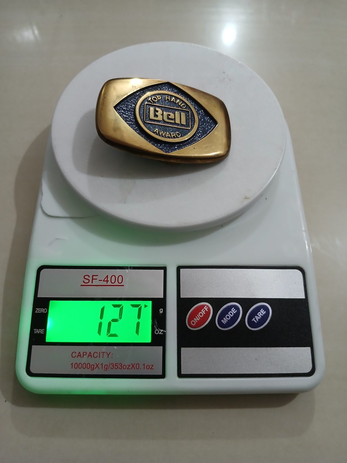 Bell Top Hand Award Vintage Belt Buckle – On scale showing weight Bell Top Hand Award vintage belt buckle – on scale showing weight