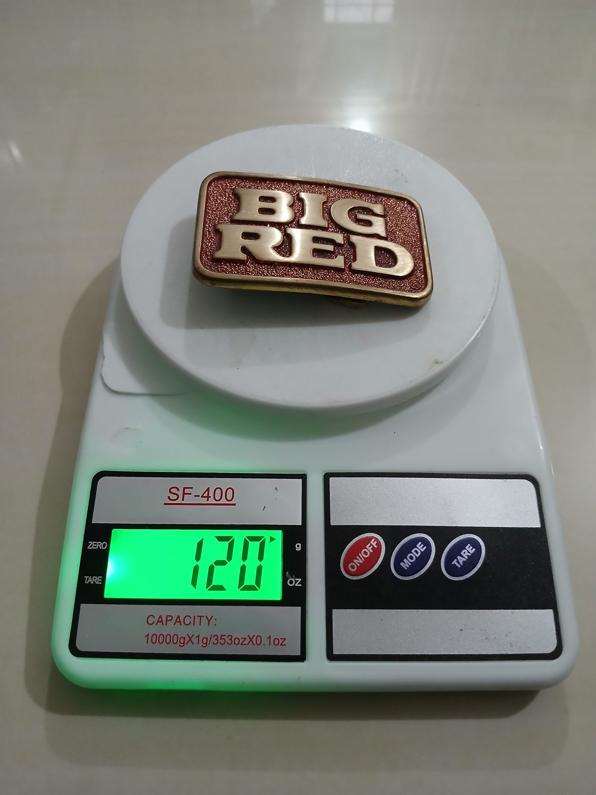 Big Red Vintage Belt Buckle – On scale showing weight Big Red vintage belt buckle – on scale showing weight