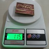 Coca-Cola vintage belt buckle – on scale showing weight