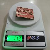 Coca-Cola vintage belt buckle – on scale showing weight