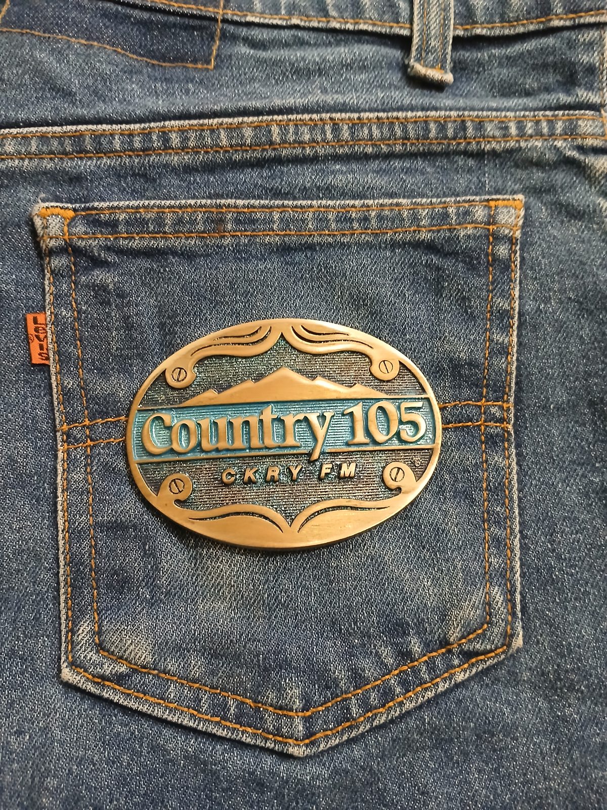 Country 105 CKRY FM Vintage Belt Buckle – On jeans back pocket Country 105 CKRY FM vintage belt buckle – on jeans back pocket