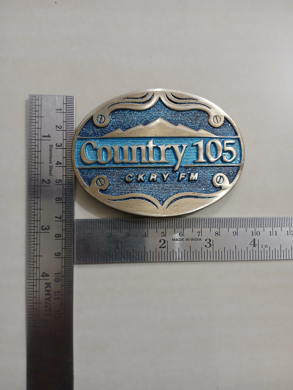 Country 105 CKRY FM Vintage Belt Buckle – With ruler for size Country 105 CKRY FM vintage belt buckle – with ruler for size