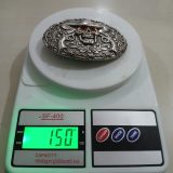 Cowboy Skull Pistols vintage belt buckle – on scale showing weight