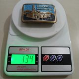 Dual Arctic Drilling Co vintage belt buckle – on scale showing weight