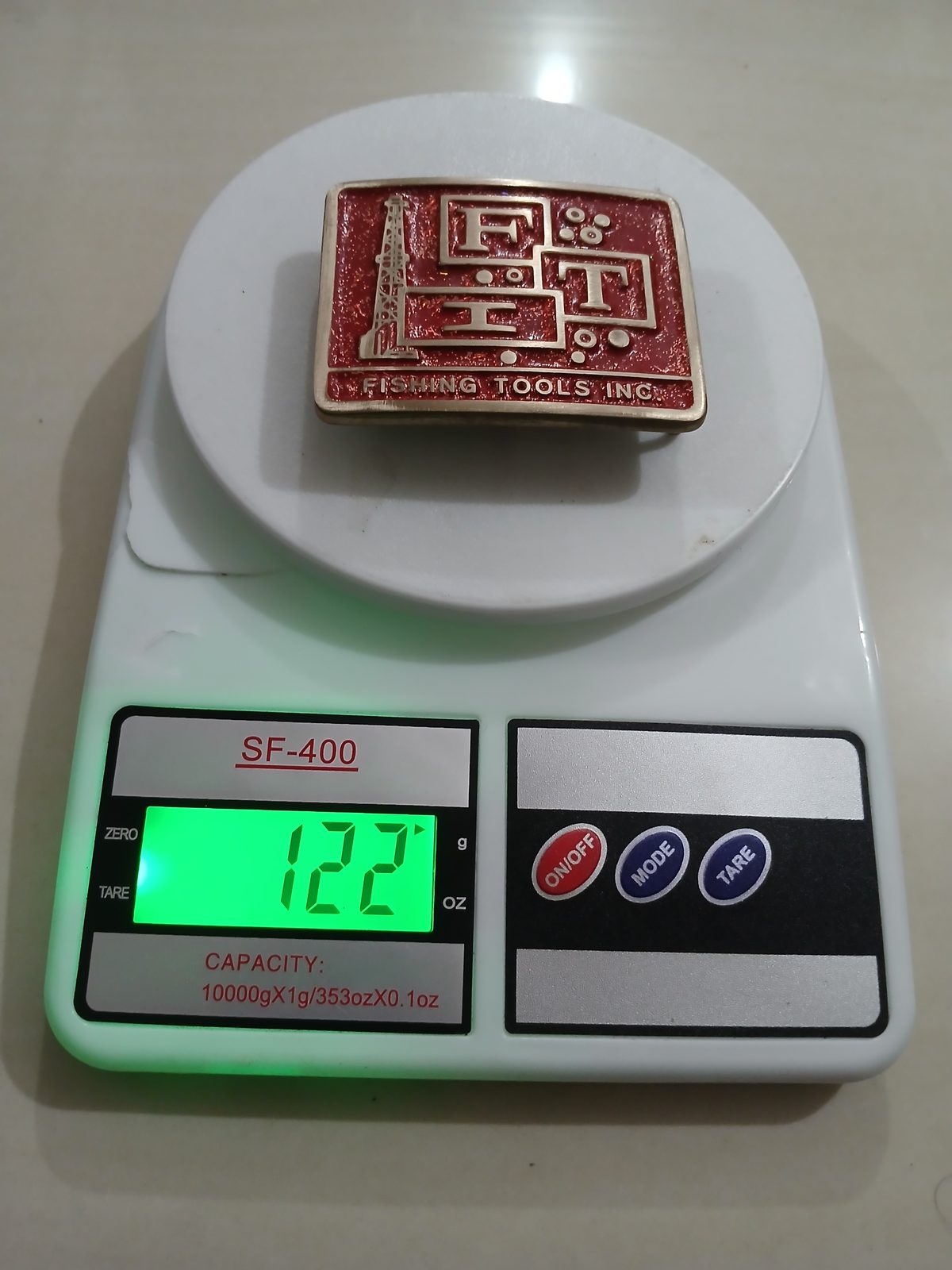 FIT Fishing Tools Inc Vintage Belt Buckle – On scale showing weight FIT Fishing Tools Inc vintage belt buckle – on scale showing weight