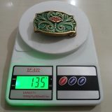 Green Floral vintage belt buckle – on scale showing weight