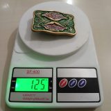 Green Floral vintage belt buckle – on scale showing weight