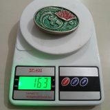 Green Floral vintage belt buckle – on scale showing weight
