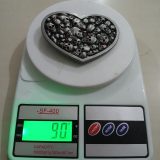 Heart Skulls vintage belt buckle – on scale showing weight