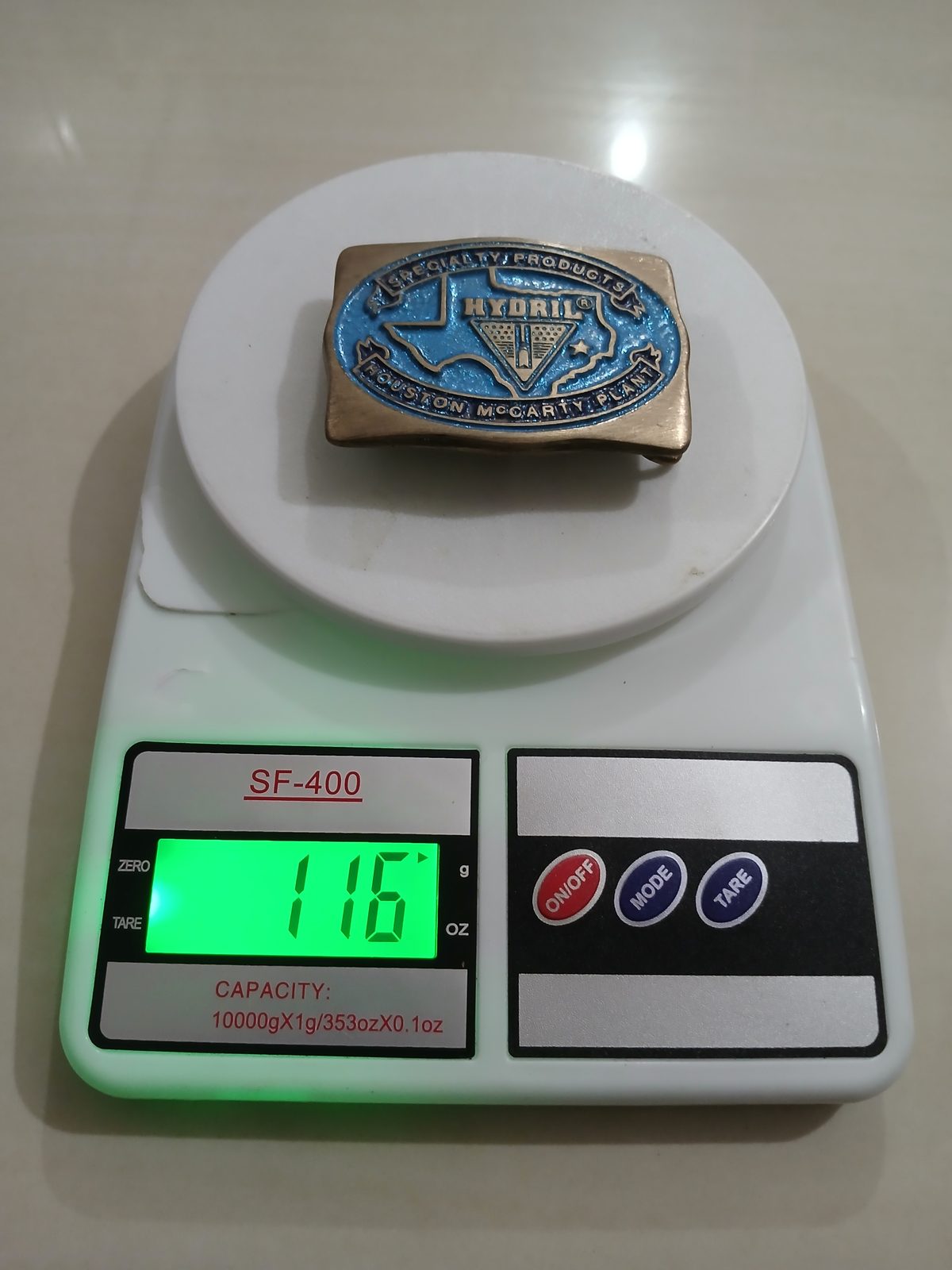 Hydril Specialty Products Houston vintage belt buckle – on scale showing weight