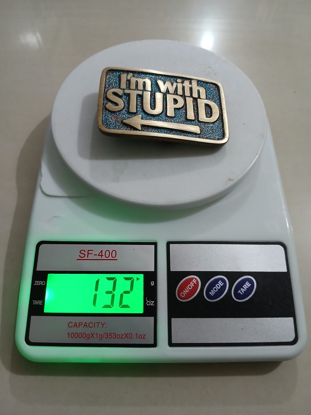 Im With Stupid Vintage Belt Buckle – On scale showing weight Im With Stupid vintage belt buckle – on scale showing weight
