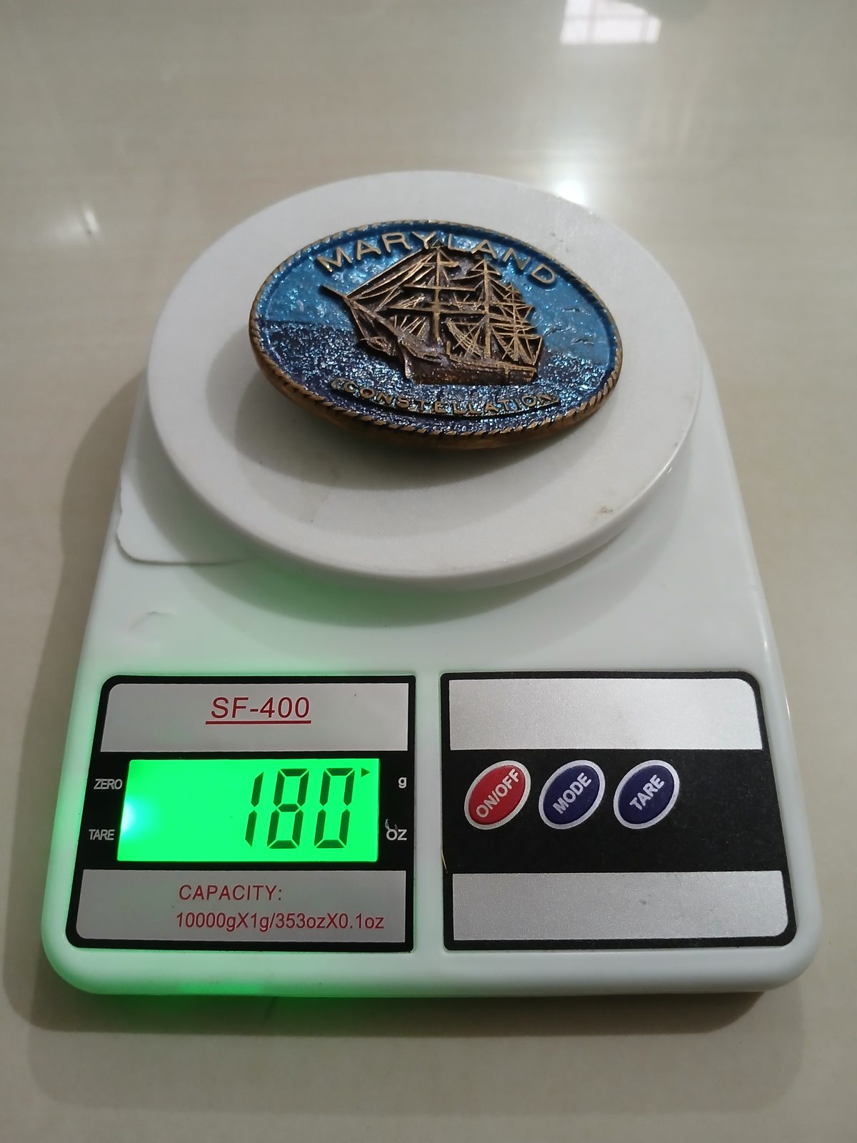 Maryland Constellation Ship Vintage Belt Buckle – On scale showing weight Maryland Constellation Ship vintage belt buckle – on scale showing weight