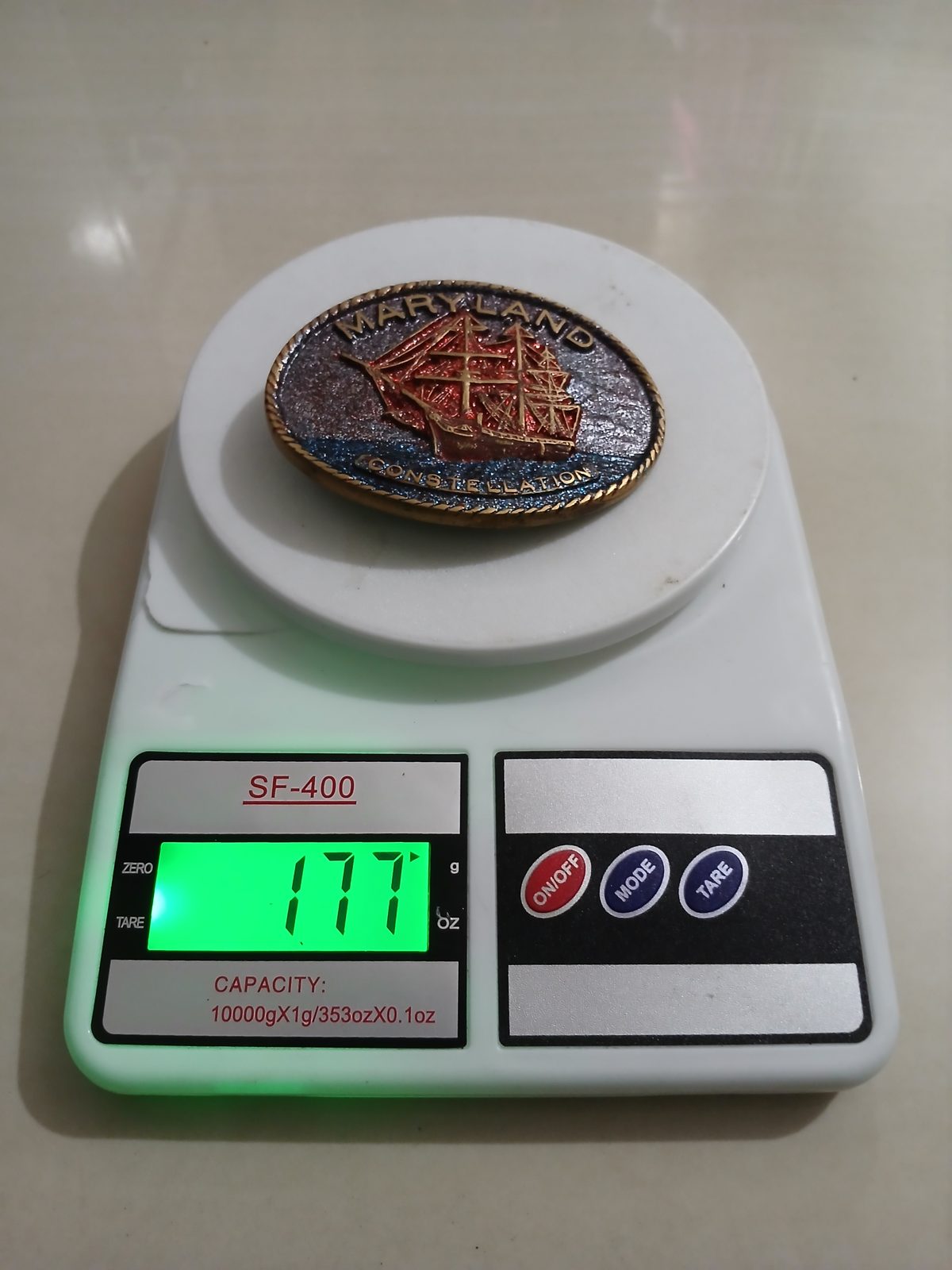 Maryland Constellation Ship Vintage Belt Buckle – On scale showing weight Maryland Constellation Ship vintage belt buckle – on scale showing weight