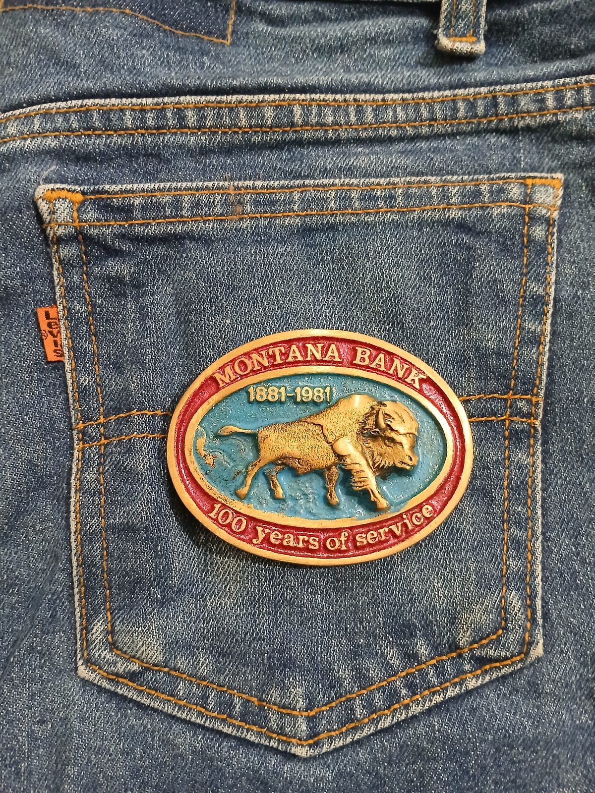Montana Bank 1881-1981 Vintage Belt Buckle – On jeans back pocket Montana Bank 1881-1981 vintage belt buckle – on jeans back pocket