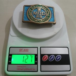 MUD Incorporated vintage belt buckle – on scale showing weight
