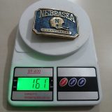 Nebraska Cornhuskers vintage belt buckle – on scale showing weight
