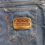 NL Basin Surveys vintage belt buckle – on jeans back pocket