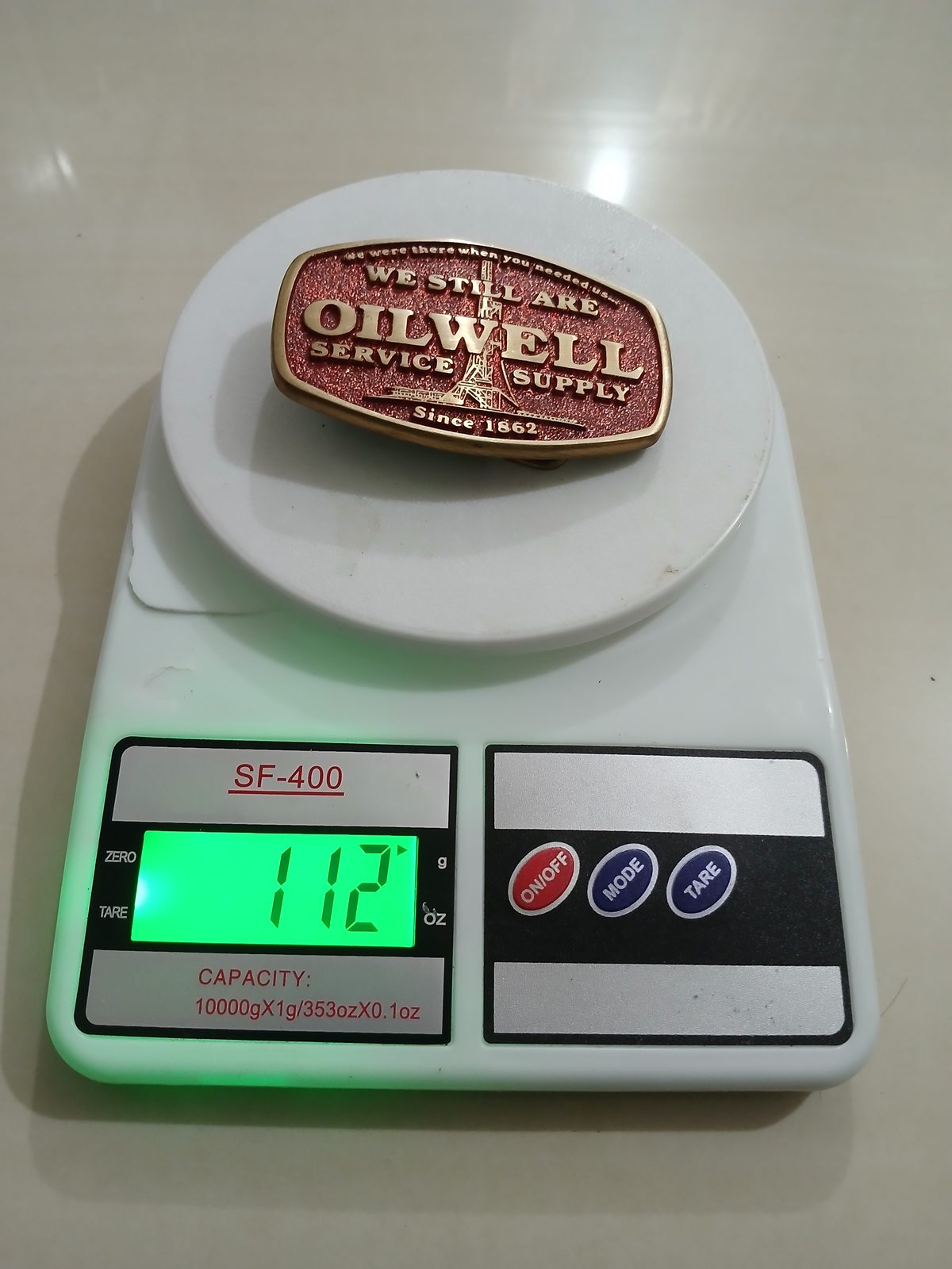 Oilwell Service Supply Vintage Belt Buckle – On scale showing weight Oilwell Service Supply vintage belt buckle – on scale showing weight