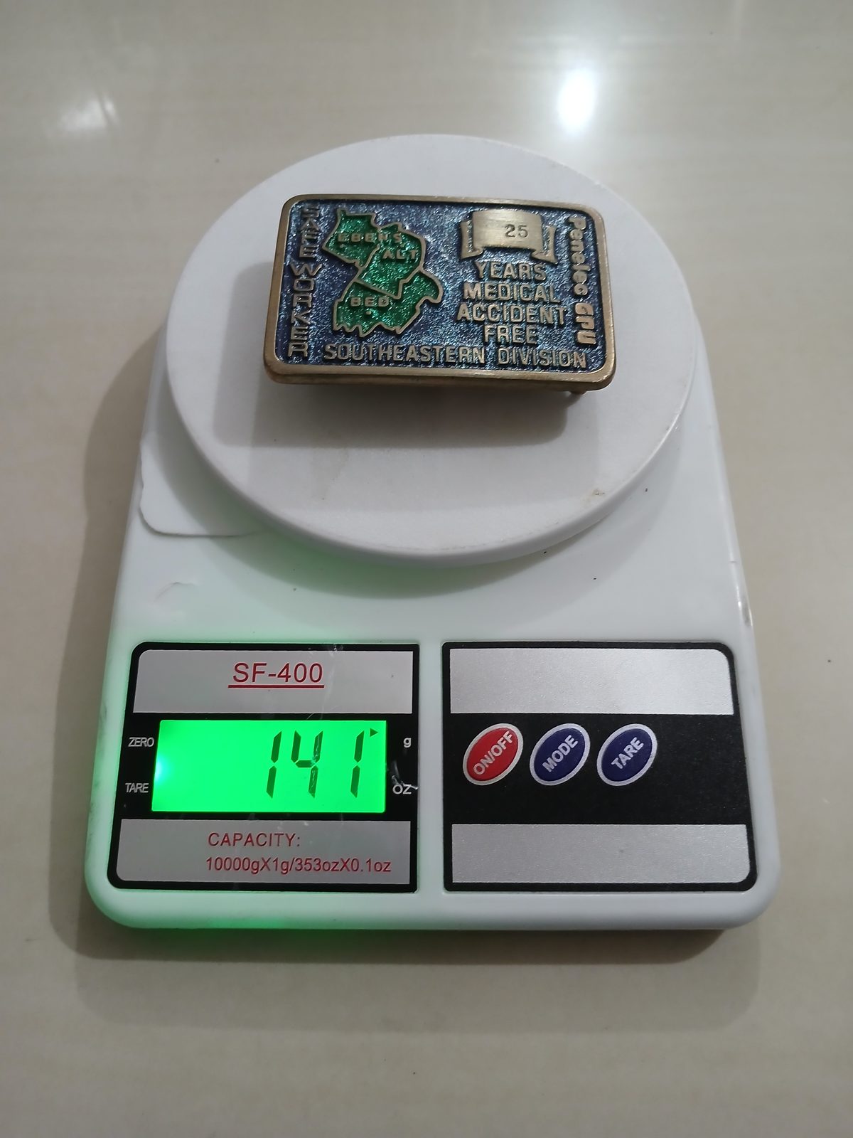 Penelec GPU 25 Years Safe Worker Vintage Belt Buckle – On scale showing weight Penelec GPU 25 Years Safe Worker vintage belt buckle – on scale showing weight
