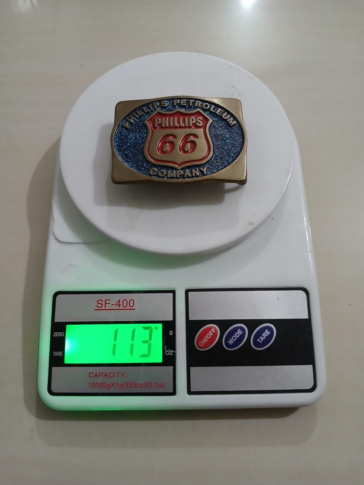 Phillips 66 Petroleum Vintage Belt Buckle – On scale showing weight Phillips 66 Petroleum vintage belt buckle – on scale showing weight