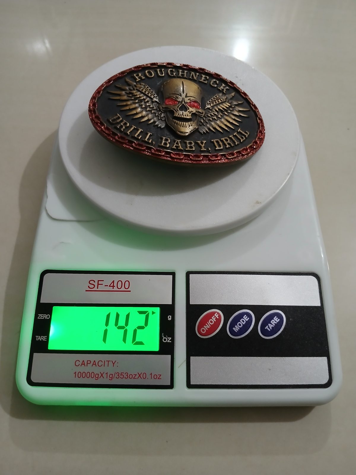 Roughneck Drill Baby Drill Vintage Belt Buckle – On scale showing weight Roughneck Drill Baby Drill vintage belt buckle – on scale showing weight