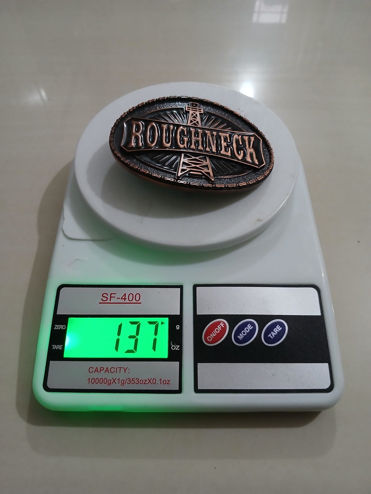 Roughneck Oil Derrick Vintage Belt Buckle – On scale showing weight Roughneck Oil Derrick vintage belt buckle – on scale showing weight