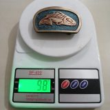 Salmon vintage belt buckle – on scale showing weight