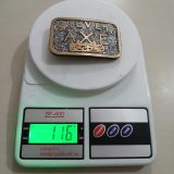 Silver Axe vintage belt buckle – on scale showing weight