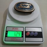 Silver Wheel Freightlines vintage belt buckle – on scale showing weight