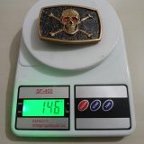 Skull Crossbones vintage belt buckle – on scale showing weight