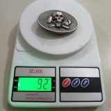 Skull Wrenches vintage belt buckle – on scale showing weight