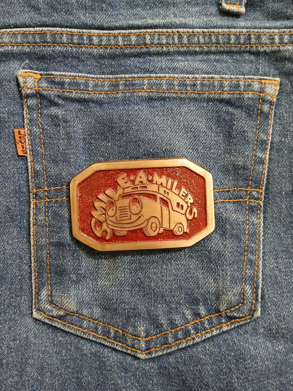 Smile-A-Milers Vintage Belt Buckle – On jeans back pocket Smile-A-Milers vintage belt buckle – on jeans back pocket
