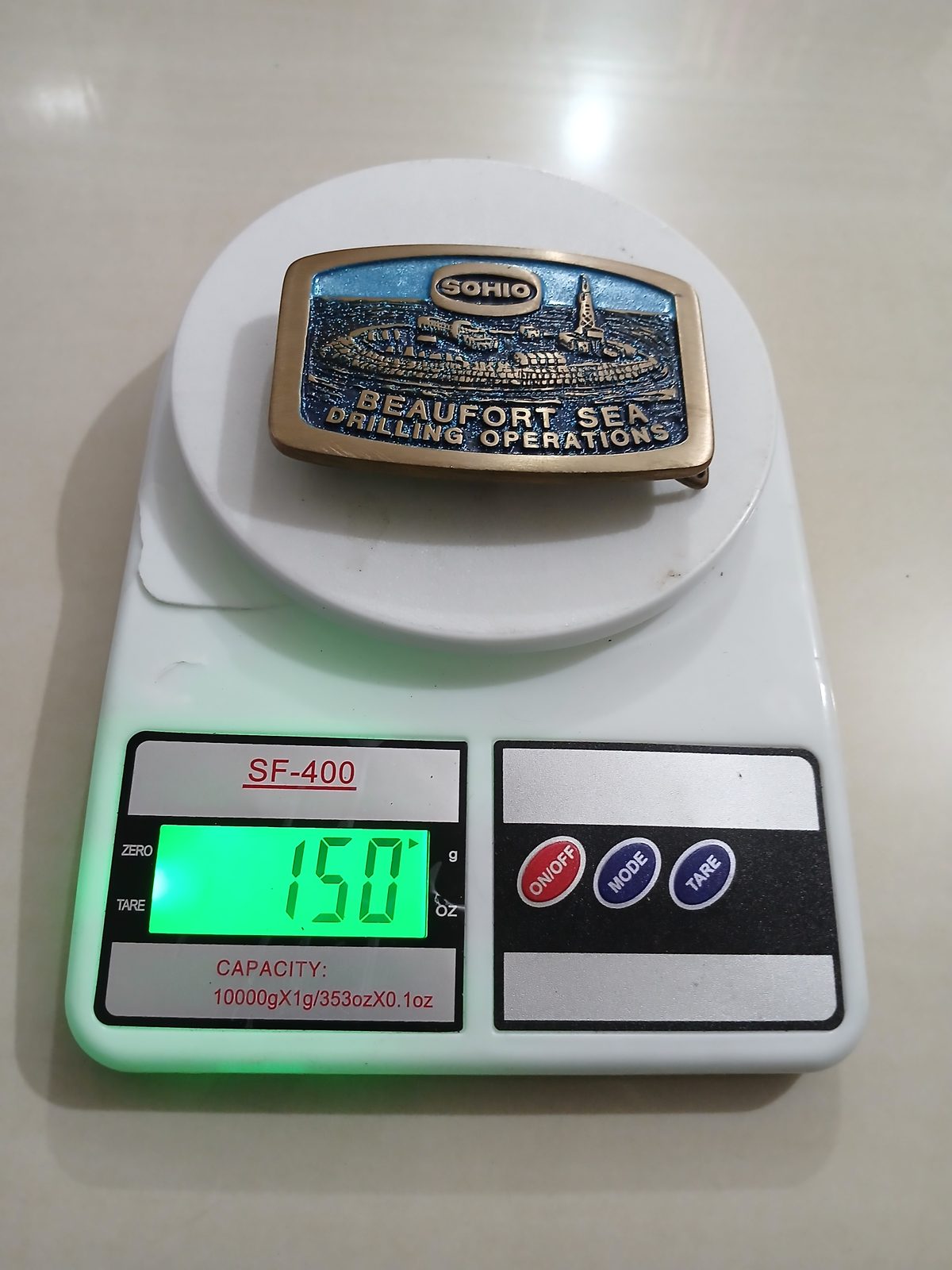 Sohio Beaufort Sea Drilling Vintage Belt Buckle – On scale showing weight Sohio Beaufort Sea Drilling vintage belt buckle – on scale showing weight
