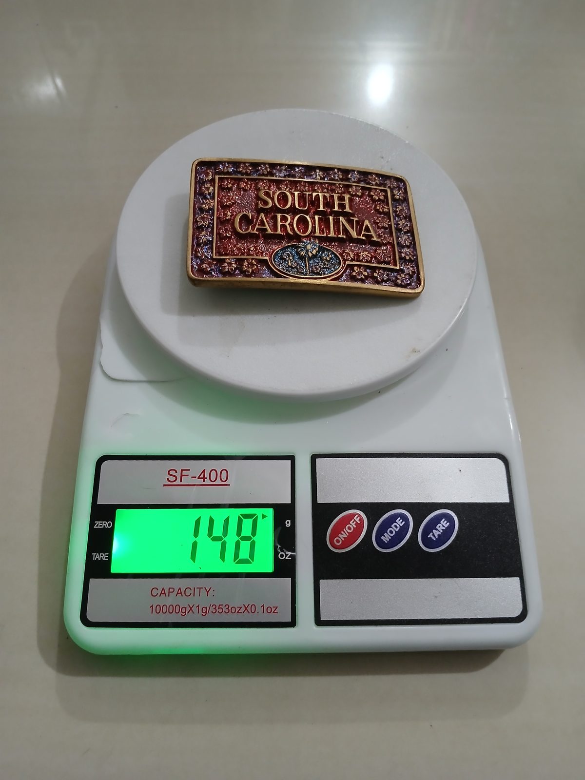 South Carolina Vintage Belt Buckle – On scale showing weight South Carolina vintage belt buckle – on scale showing weight