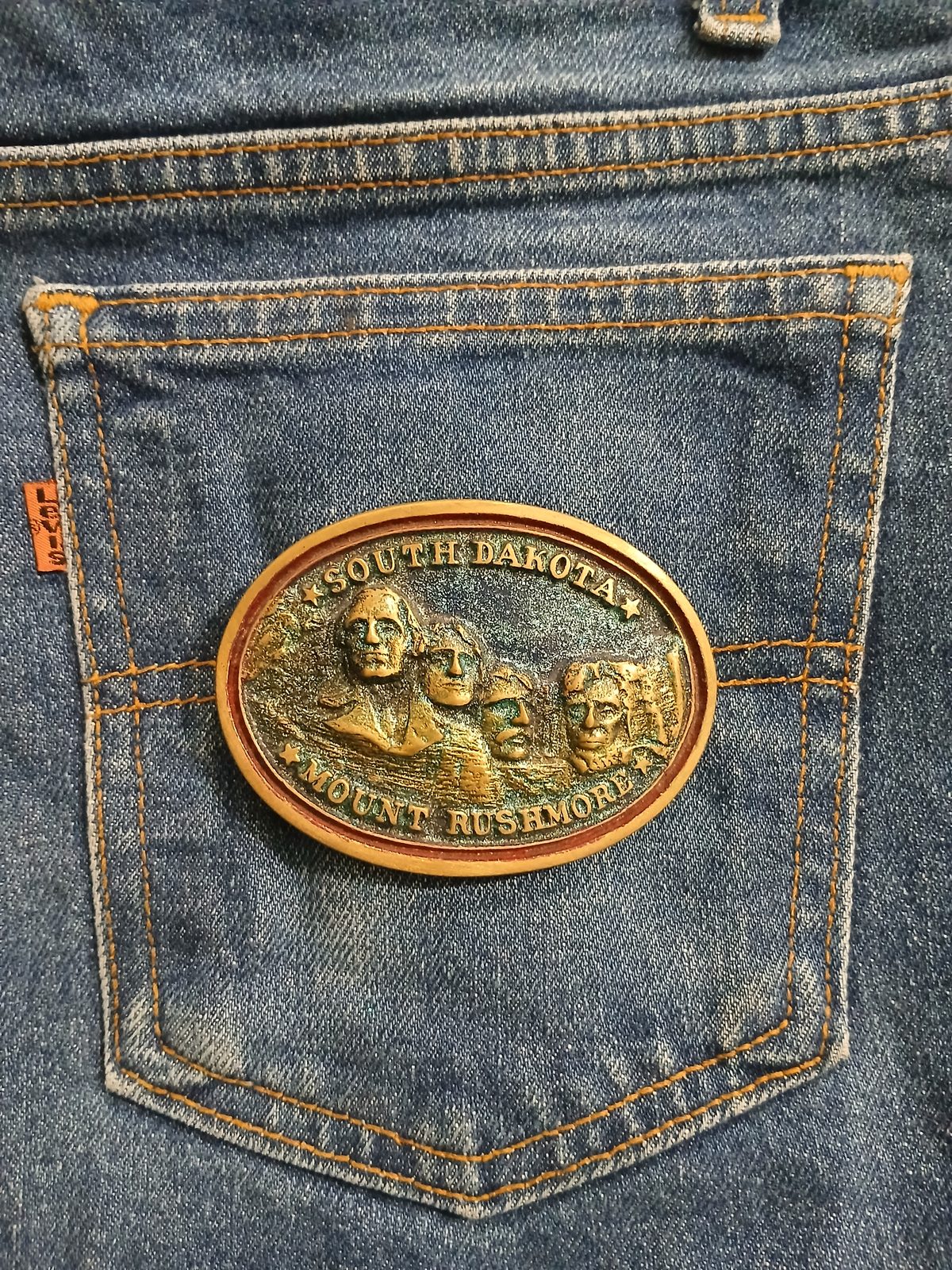 South Dakota Mount Rushmore Vintage Belt Buckle – On jeans back pocket South Dakota Mount Rushmore vintage belt buckle – on jeans back pocket