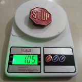 Stop Sign vintage belt buckle – on scale showing weight