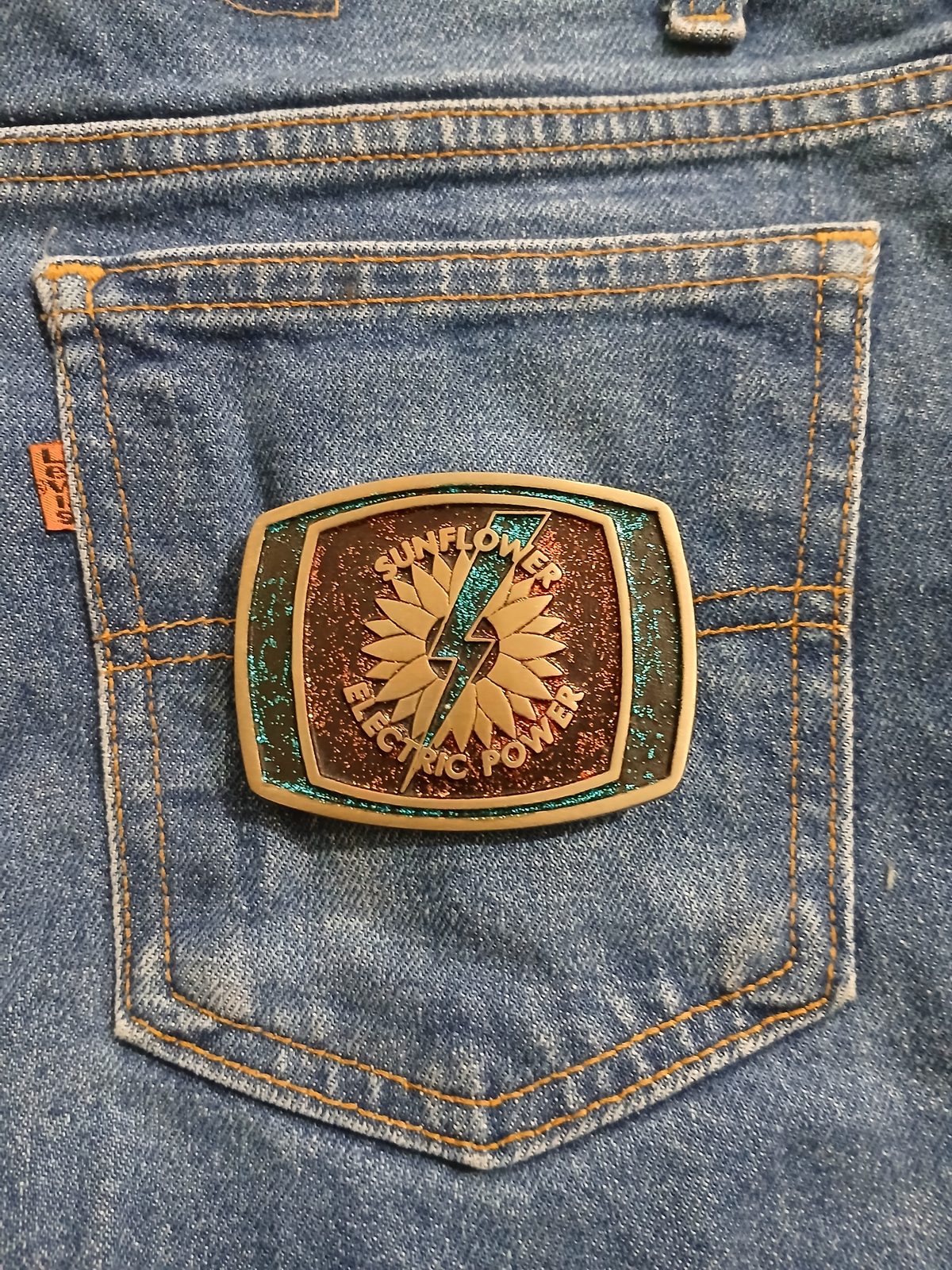 Sunflower Electric Power Vintage Belt Buckle – On jeans back pocket Sunflower Electric Power vintage belt buckle – on jeans back pocket