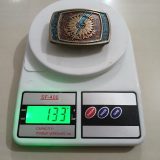 Sunflower Electric Power vintage belt buckle – on scale showing weight