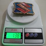 Suzuki vintage belt buckle – on scale showing weight