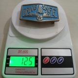 Texaco Drive Safe vintage belt buckle – on scale showing weight