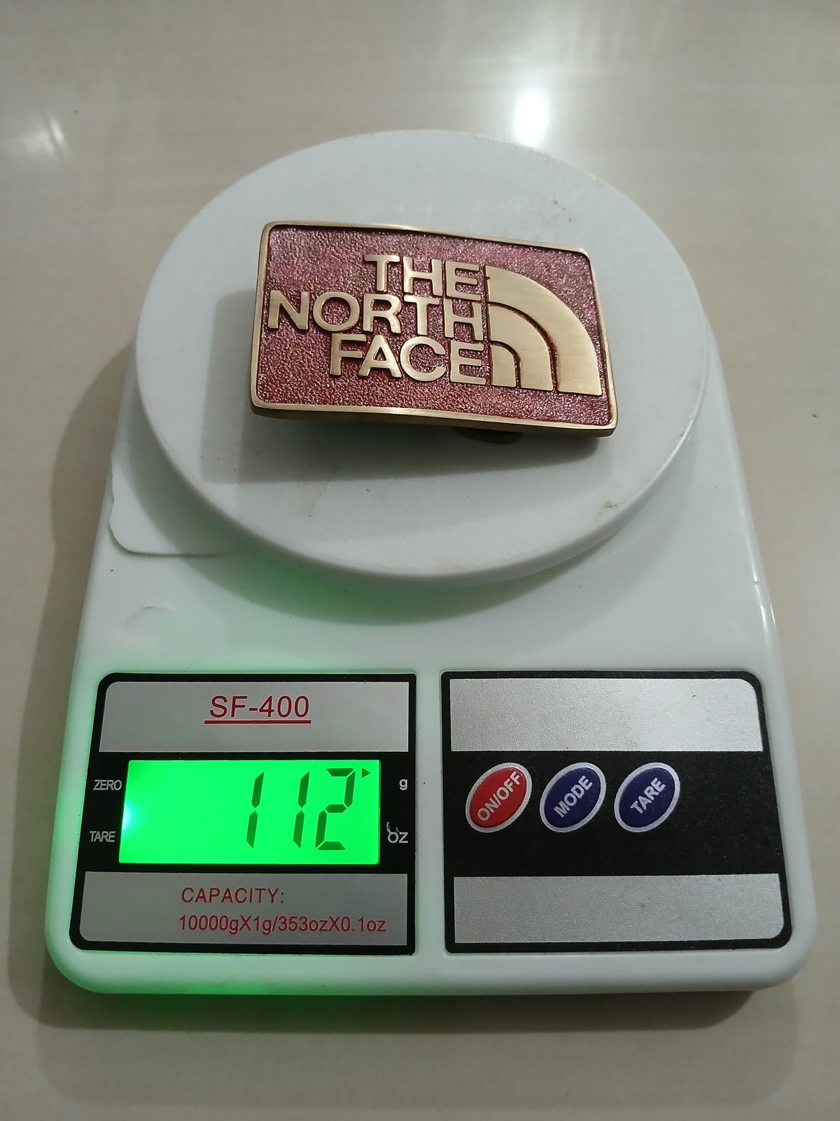 The North Face Vintage Belt Buckle – On scale showing weight The North Face vintage belt buckle – on scale showing weight