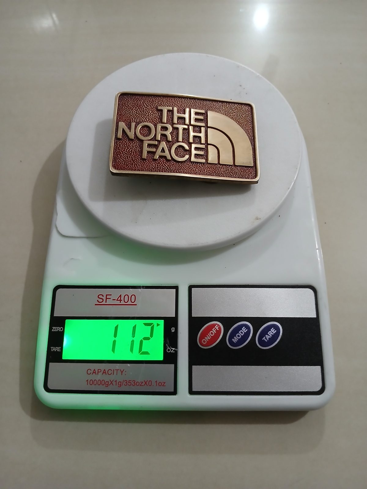 The North Face Vintage Belt Buckle – On scale showing weight The North Face vintage belt buckle – on scale showing weight