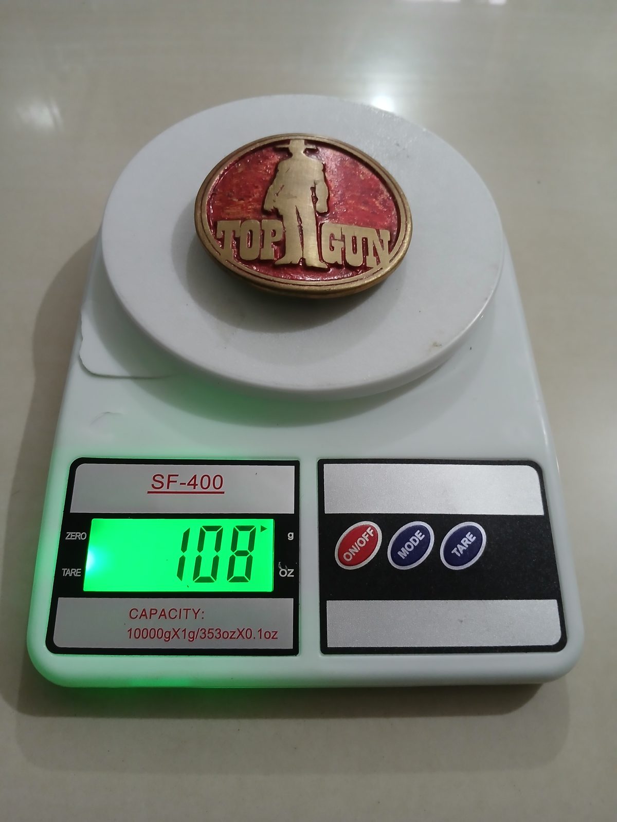 Top Gun Vintage Belt Buckle – On scale showing weight Top Gun vintage belt buckle – on scale showing weight