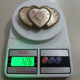 Triple Heart Floral vintage belt buckle – on scale showing weight
