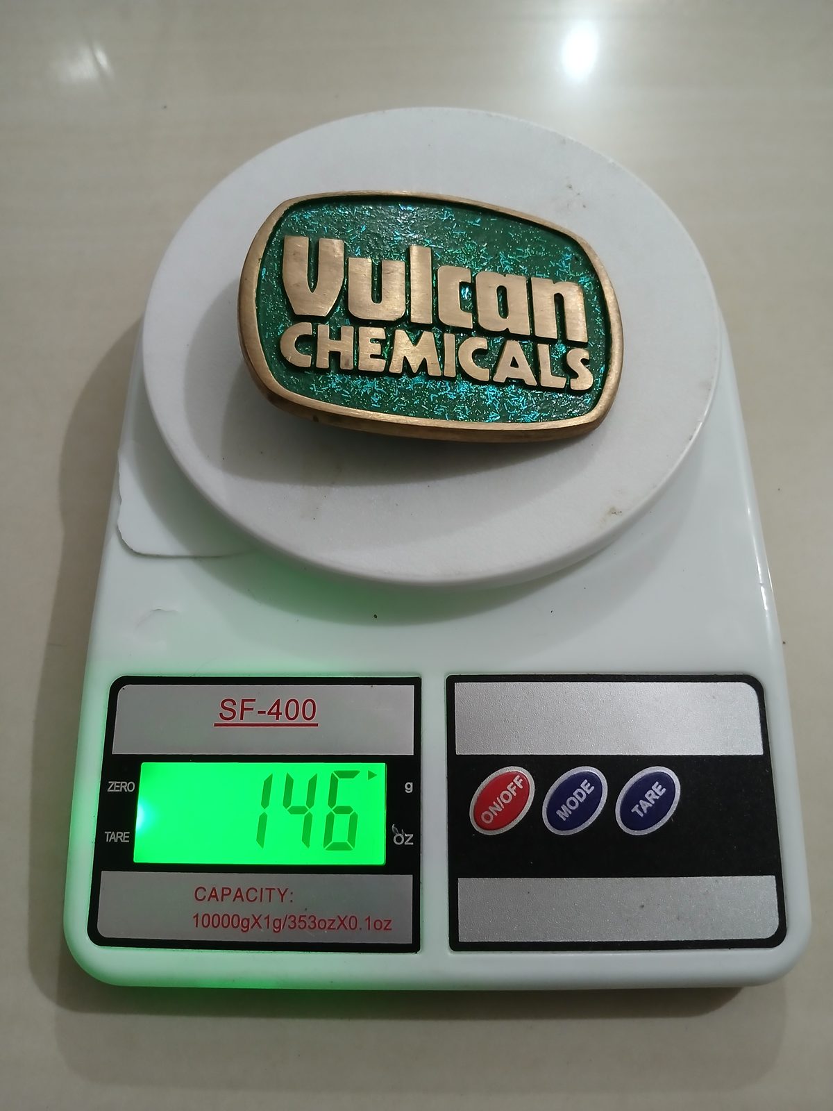 Vulcan Chemicals Vintage Belt Buckle – On scale showing weight Vulcan Chemicals vintage belt buckle – on scale showing weight